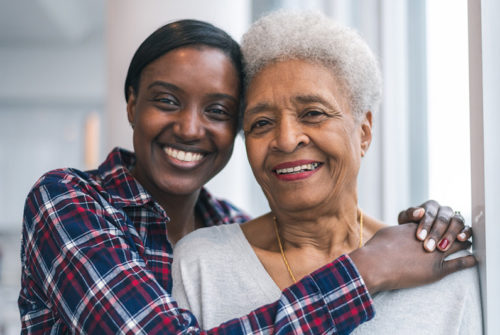 daughter-and-senior-mother-smiling-portrait